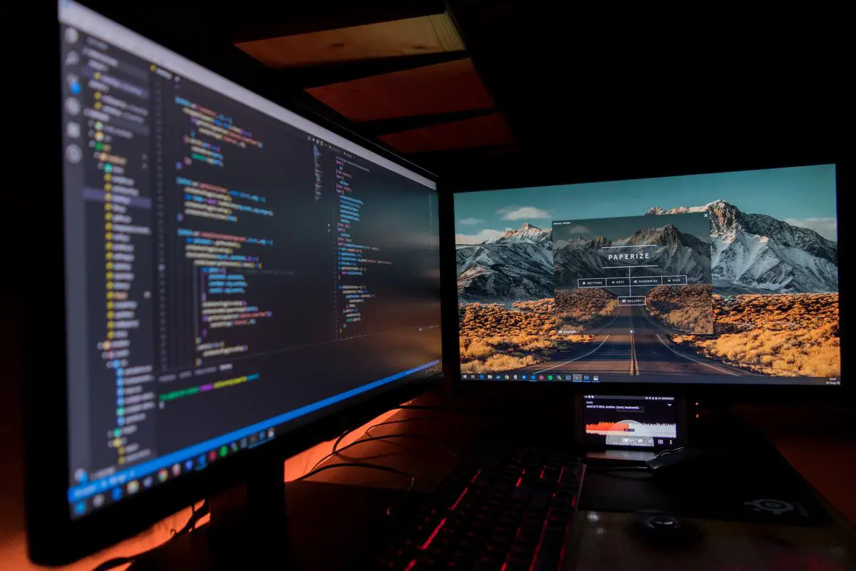 A dual monitor setup with two monitors connected to a laptop docking station.