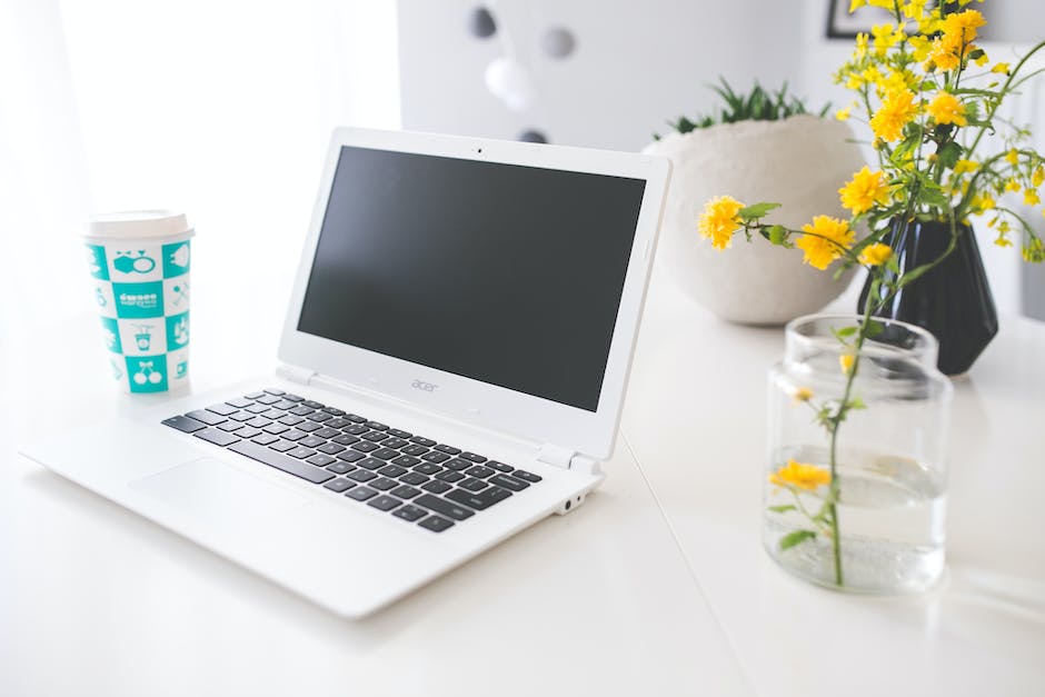 A person holding a Lenovo Chromebook, depicting the troubleshooting steps for software glitches